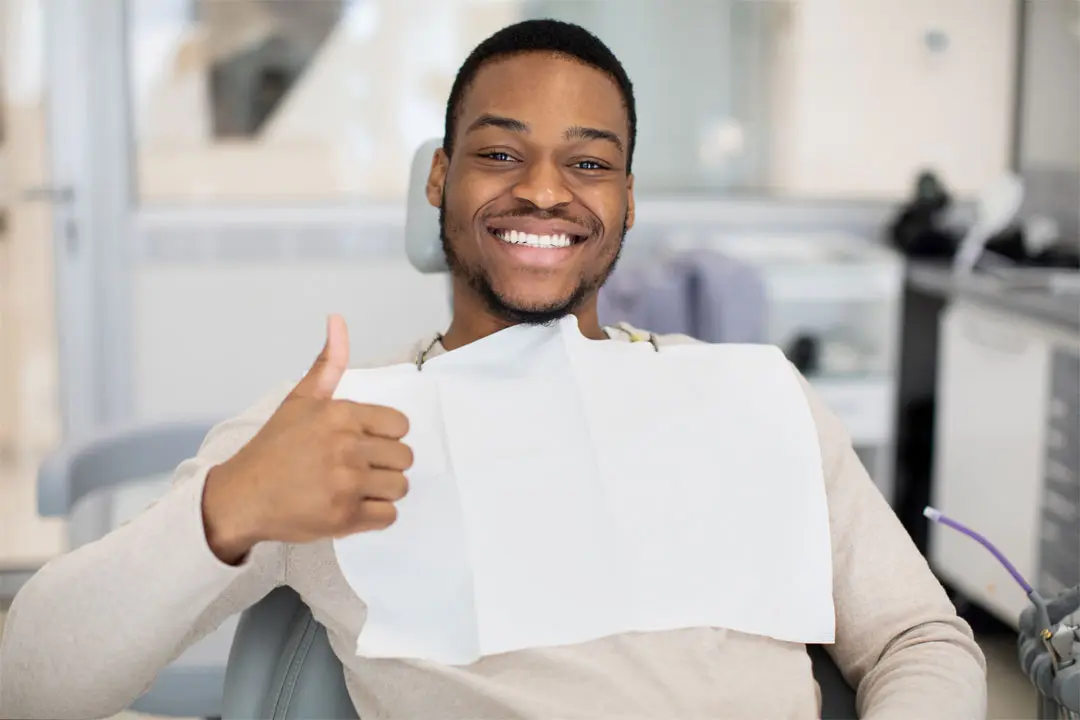 dental patient giving thumbs up
