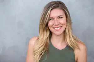 Natural blonde smiling on grey background