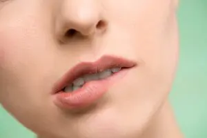 Photo by Shiny Diamond: https://www.pexels.com/photo/woman-biting-her-lips-3762440/ - woman with a worried lip and showing her teeth