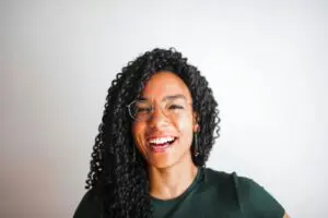 https://www.pexels.com/photo/a-photo-of-a-happy-woman-3765146/ smiling woman wearing glasses with curly hair