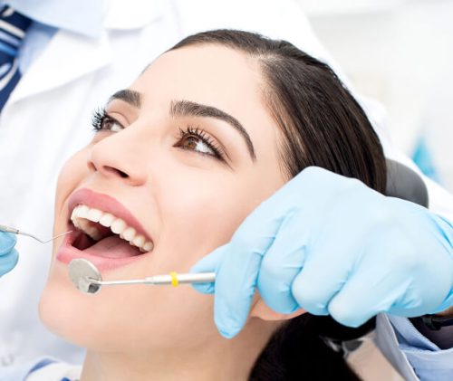 woman patient receiving dental exam